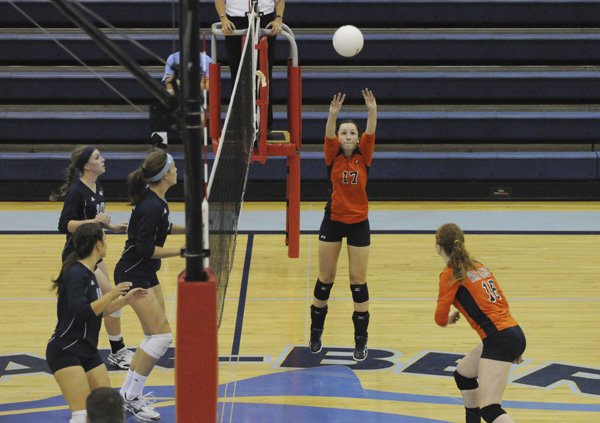 Rogers Heritage’s Kaylin Anderson sets the ball to Samantha Ligi during a match against Springdale Har-Ber on Oct. 12 in Springdale.