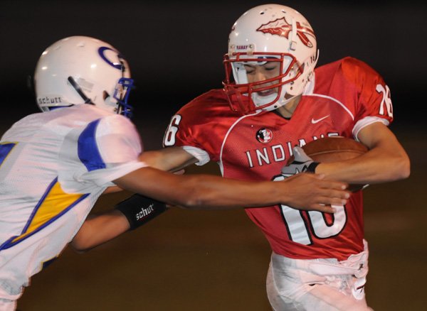 Fayetteville Ramay’s Tristan Stalbaum stiff-arms a Springdale Central defender on Oct. 14 at Harmon Field in Fayetteville.