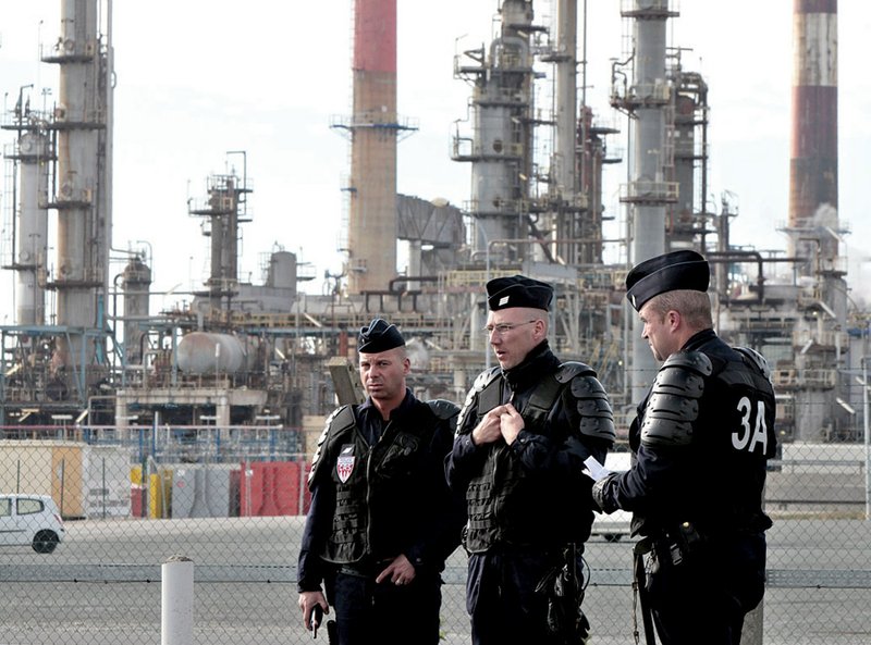 Riot police officers stand at the Grandpuits refinery, eastern Paris, Friday Oct. 22, 2010. 