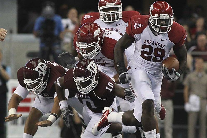Broderick Green runs through Texas A&M defenders during the first quarter of the Razorbacks 24-17 victory Saturday at Cowboys Stadium.