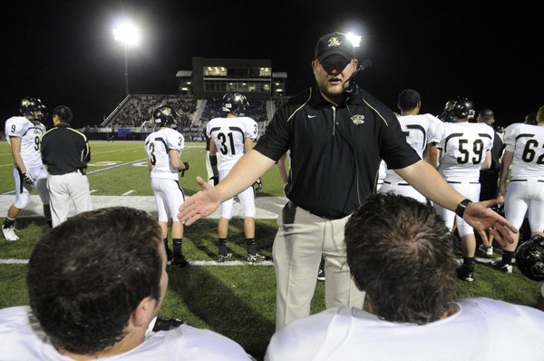 Bentonville offensive line coach Aaron Danenhauer talks to his players during the Tigers’ game Friday against Rogers High in Mountie Stadium in Rogers.