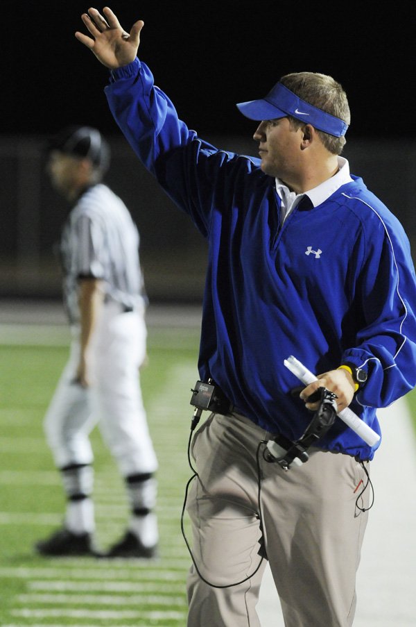 Jonathan Brewer, a former Rogers quarterback and assistant coach, will be an assistant coach for Harrison next season.