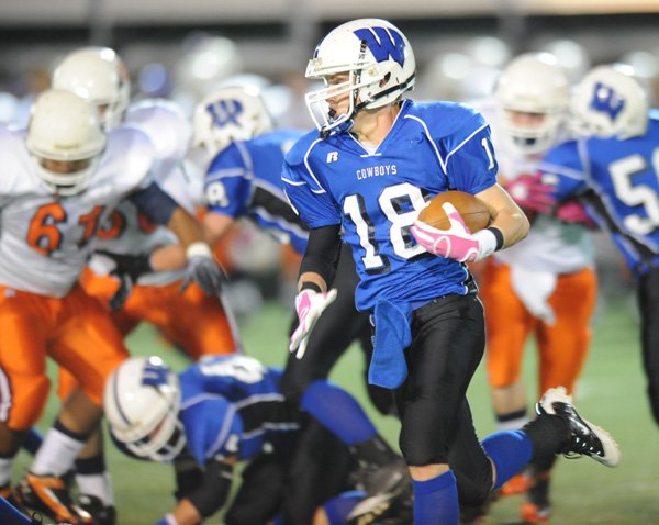 Fayetteville Woodland’s Alan Dunn carries the ball through the Springdale Southwest defense during the first half of Thursday’s junior high game at Harmon Field.
