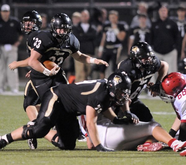 Bentonville running back Garrett Kaufman carries the ball on Oct. 22 against Fort Smith Northside in Tiger Stadium in Bentonville.