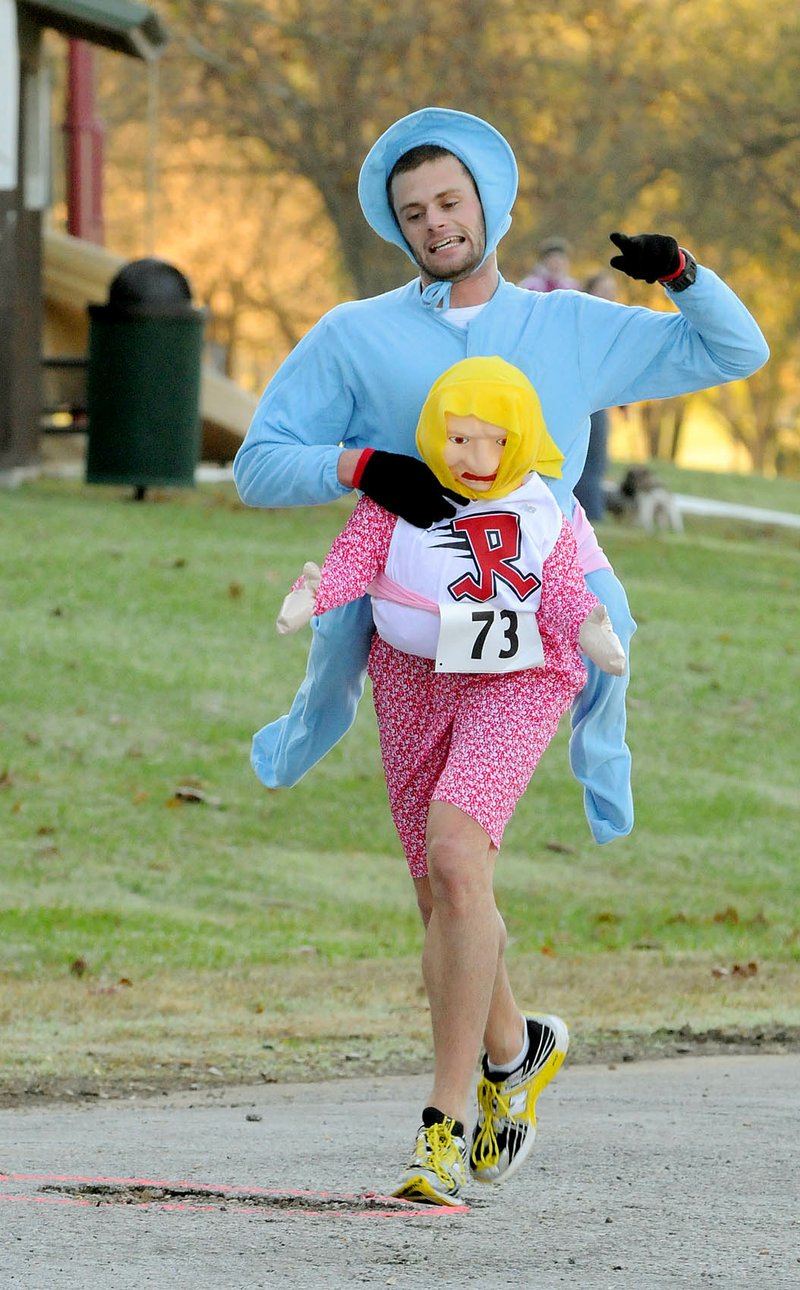 FASTER GRANNY The infant Drew Conner rode on the back of  a poor old woman to win Halloween 5K with a time of 17:47 at Lake Bella Vista on Saturday. The 5k and Fun Run was a fund raiser for the non-profit Rebuilding Together which helps rebuild the homes of people in need. 