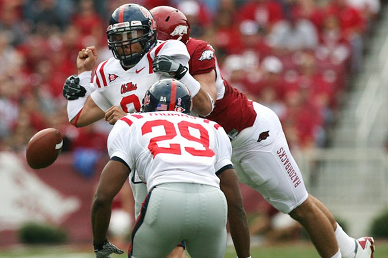 Arkansas defensive lineman Jake Bequette (right) sacks Mississippi quarterback Jeremiah Masoli and forces a fumble in the first quarter following an Arkansas turnover.
