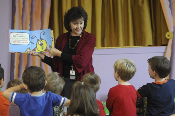 Lolly Greenwood reads to children during Preschool Story Time on Oct. 13 at the Fayetteville Public Library. Greenwood has been manager of Youth Services for 16 years.