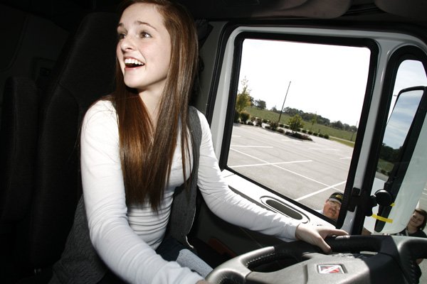 Isabelle Cosgriff, 16, of Rogers tries to identify a vehicle in the “blind spot” of a parked semi-tractor during an Oct. 16 class of the Driving Academy of Northwest Arkansas. This session, held at the First Church of the Nazarene in Rogers, was aimed at teaching young drivers the importance of being aware of other drivers’ blind spots, large trucks and motorcycles.
