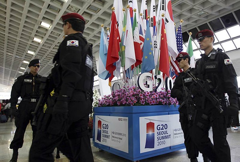 South Korean officers stand guard near the symbol of the Group of 20 nations at Gimpo Airport in Seoul on Monday. 
