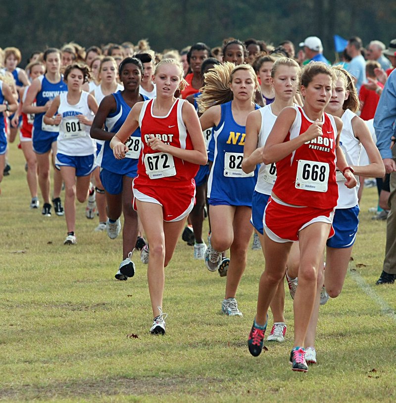 EmKay Myers (668), a junior at Cabot High School, leads the field from the start enroute to winning the 7A Central Conference Cross Country meet with a time of 19.38 at Rolling Hills Golf Course in Cabot on Monday.