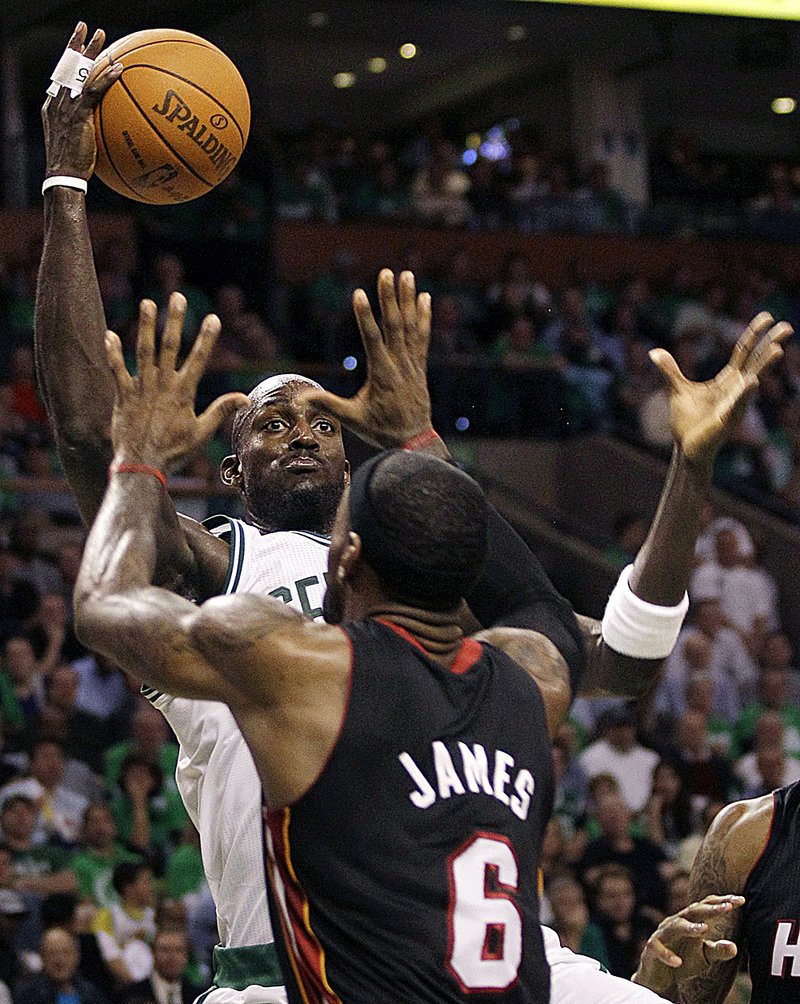 Boston’s Kevin Garnett shoots over Miami’s LeBron James in the first half of the Celtics’ 88-80 victory in the NBA season-opener for both teams.