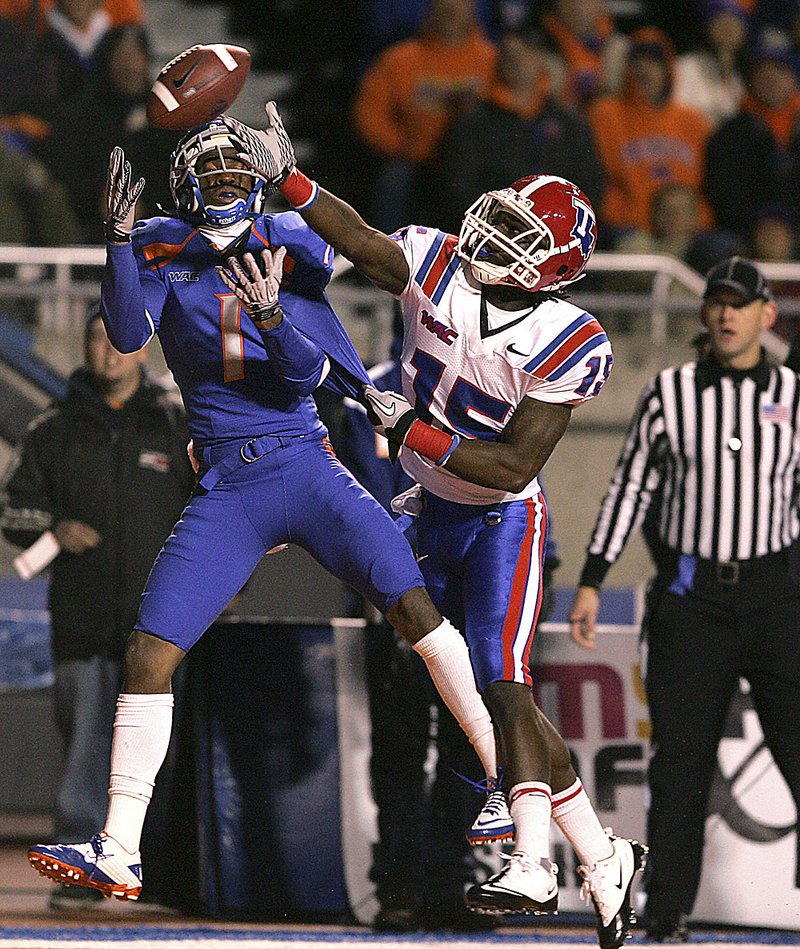 Boise State’s Titus Young (1) attempts to catch a pass against Louisiana Tech’s Josh Victorian (15) during the first half of the No. 3 Broncos’ 49-20 victory over the Bulldogs on Tuesday in Boise, Idaho. The pass was incomplete. 