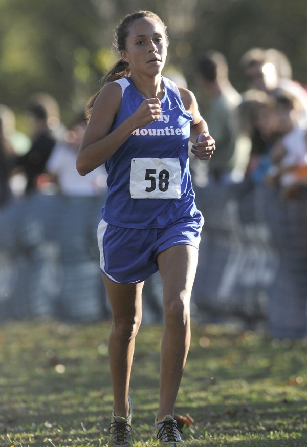 Rogers High’s Maggie Montoya finishes the 7A-West Conference Girls Cross Country Meet on Tuesday at Agri Park in Fayetteville. Montoya finished second with a time of 18 minutes, 47 seconds. 