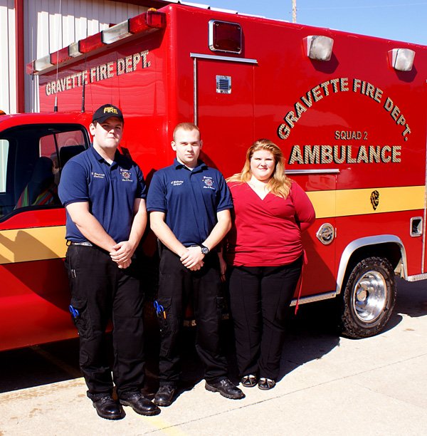 ravette Emergency Medical Technicians stand in front of one of the Gravette ambulances which serve a large area of Northwest Benton County. From the left, Lt. Glenn Boughman, Spencer Gillming and Star Butler, EMS coordinator.