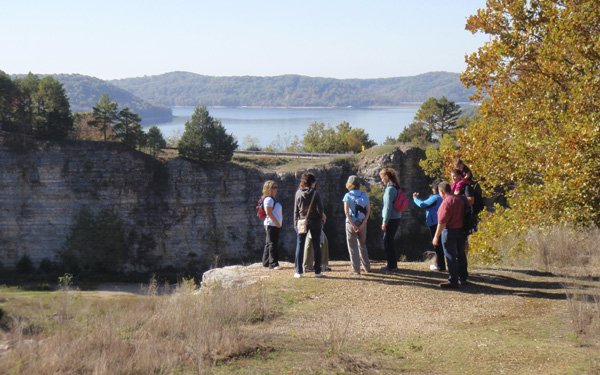 Hikers pause along the Dogwood Overlook Trail on Friday at Beaver Lake. The 2-mile trail is one of several hiking trails at the lake. It visits the quarry site where rock was obtained for Beaver Dam and features stunning views of the lake.