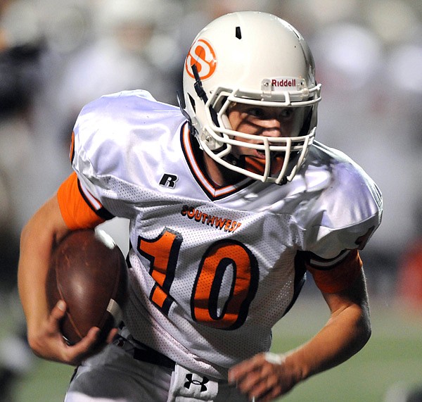 Springdale Southwest quarterback Braxton Jester scrambles for a first down during the first half Sept. 30 against Rogers Heritage in Gates Stadium in Rogers.