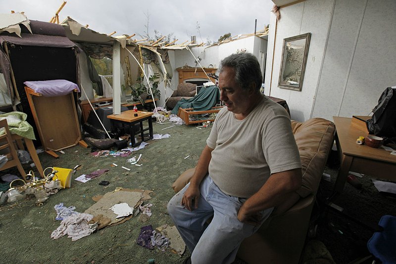 Jack Hambrick sits inside his storm-damaged home Wednesday in Vale, N.C.

