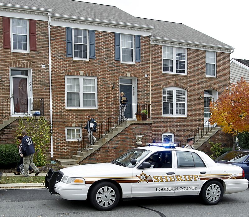 FBI and law enforcement investigators leave the Ashburn, Va., home of Farooque Ahmed on Wednesday. 