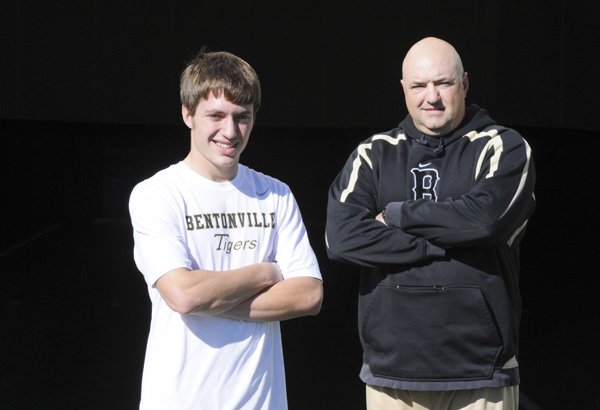 Bentonville cornerback Dallas Coleman, left, stands for a portrait with his father, Rob, on Thursday.