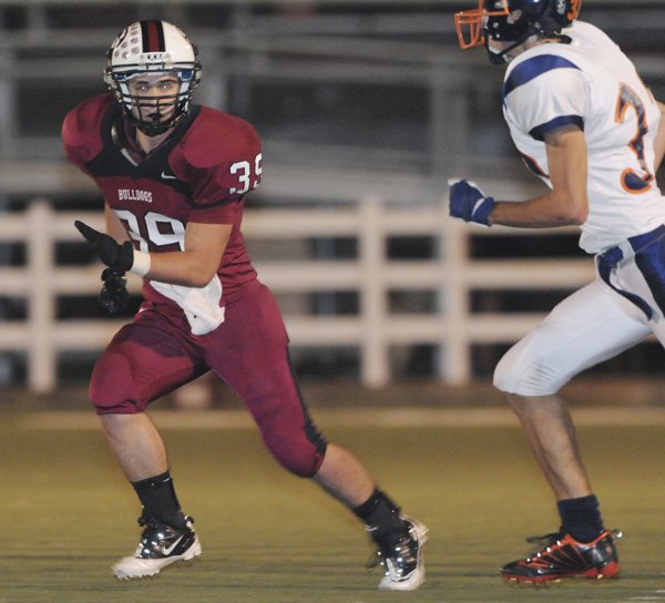 Springdale High’s Keenan Sanchez runs past a Rogers Heritage defender in the first half Oct. 22 in Springdale.