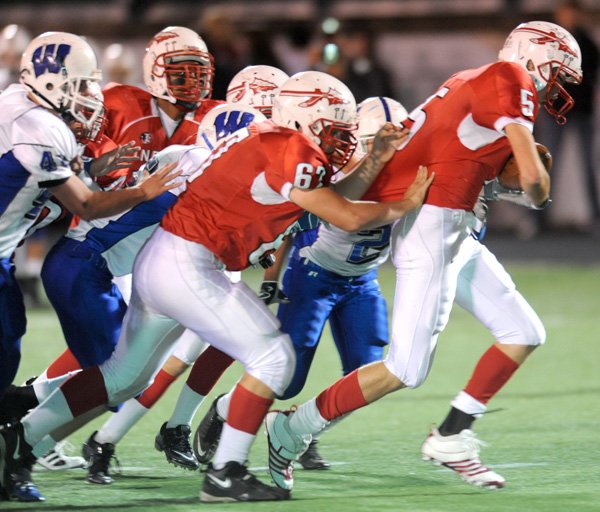 Fayetteville Ramay running back Aaron Kildow carries would-be Woodland tacklers into the end zone during the second quarter Thursday in Harmon Field. Go to nwaonline.com/photoreprints to see more photos.