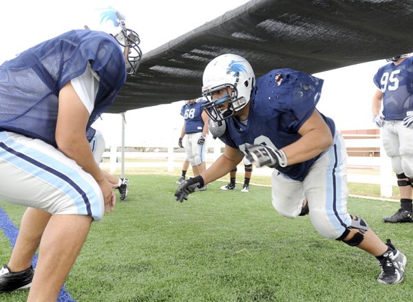 Springdale Har-Ber senior Paco DeLuna leaps from the ready stance during drills at practice Wednesday in Springdale.