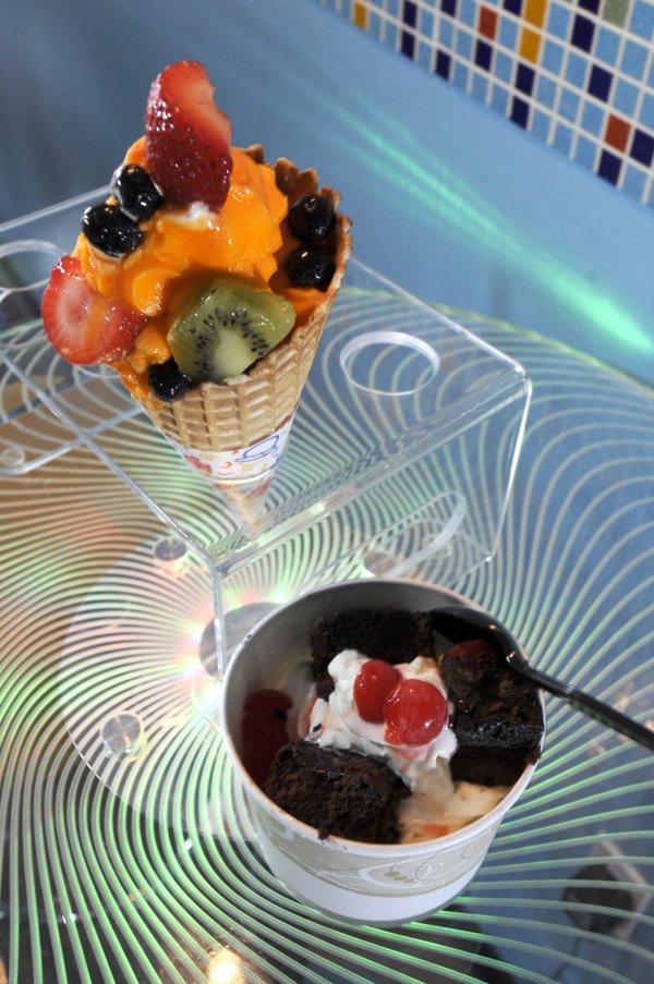 A waffle cone filled with Valencia orange sorbet topped with fresh fruit and a cup of white chocolate mousse frozen yogurt with cherries and brownie chunks are just two of the many combinations to be had at YumYos Help Yo Self Frozen Yogurt in Bentonville.