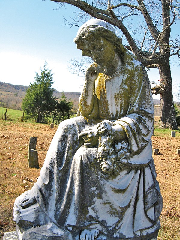 This tombstone, photographed in the Watts Cemetery in Searcy County, is a beautiful example of the haunting imagery that encourages the telling of chilling tales.