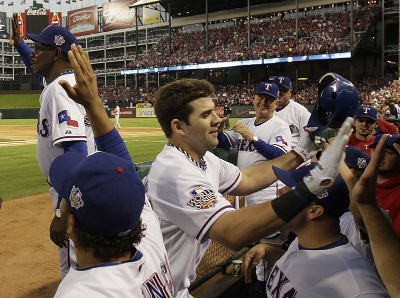Texas first baseman Mitch Moreland is congratulated in the dugout after a three-run, second-inning home run that gave the Rangers a lead they wouldn’t lose in a 4-2 victory. 