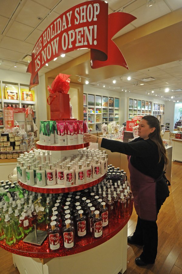 Lucy Overstreet of Fayetteville works Thursday at Bath & Body Works at the Northwest Arkansas Mall. She started work in mid-October and plans to stay on until after the holidays.