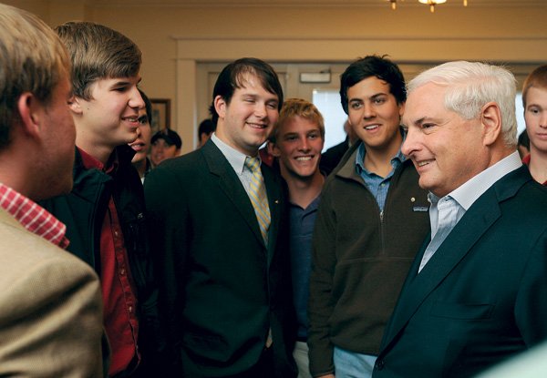 Panamanian president Ricardo Martinelli, right, talks Saturday with members of the Sigma Nu fraternity at the fraternity’s house on the University of Arkansas campus. Martinelli, an Arkansas alumnus, visited with the members and also with old friends after speaking about his life lessons.