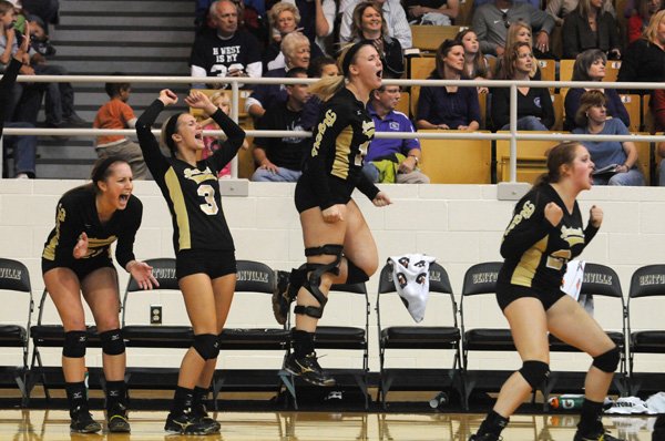 Bentonville volleyball players celebrate Saturday after winning the fourth match to force a fifth match against Fayetteville during the finals of the Class 7A State Volleyball Tournament at Bentonville High School.