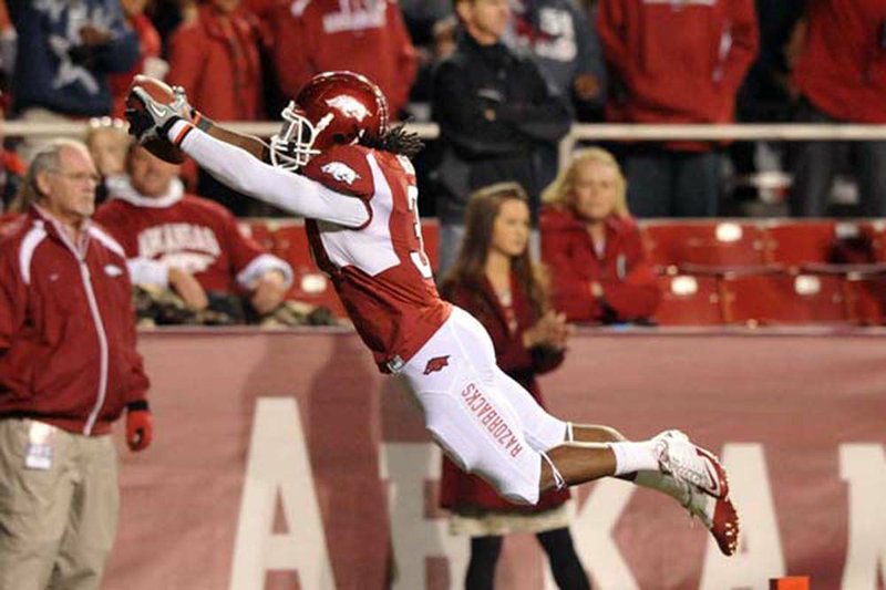 Arkansas’ Jerico Nelson dives into the end zone to score on an interception in the fourth quarter Saturday at Fayetteville He was flagged for the leap. 
