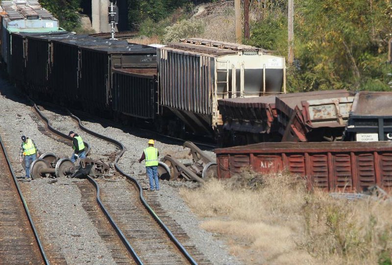 Union Pacific workers examine the scene of a train derailment near West 17th Street in Little Rock on Sunday morning. No one was hurt in the accident. 