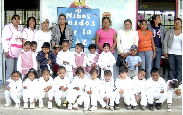 Carolina Morales, (back, left), stands with a class of the Lauro Aguirre Kinder in Celaya, Guanajuato, Mexico, where she taught kindergarten.
