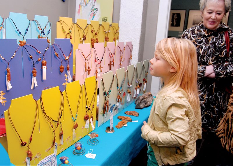 Emillyana Kejser, 7, of Hot Springs checks out necklaces on display at Handmade for the Holidays on Nov. 13 at the Artchurch Studio in Hot Springs while shopping with her grandmother Eva Andres, who was visiting from Florida.