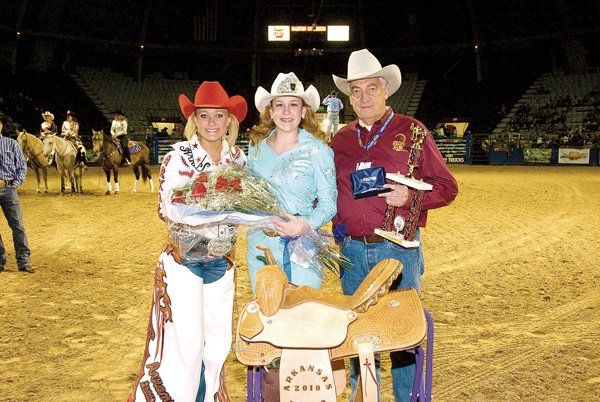 Stephanie Kaeppel of Conway, center, receives her trophy and saddle from Ralph Shoptaw, general manager of the Arkansas State Fair, and a bouquet of roses from 2009 Arkansas State Fair Rodeo Queen Kirby Allen of Springdale.