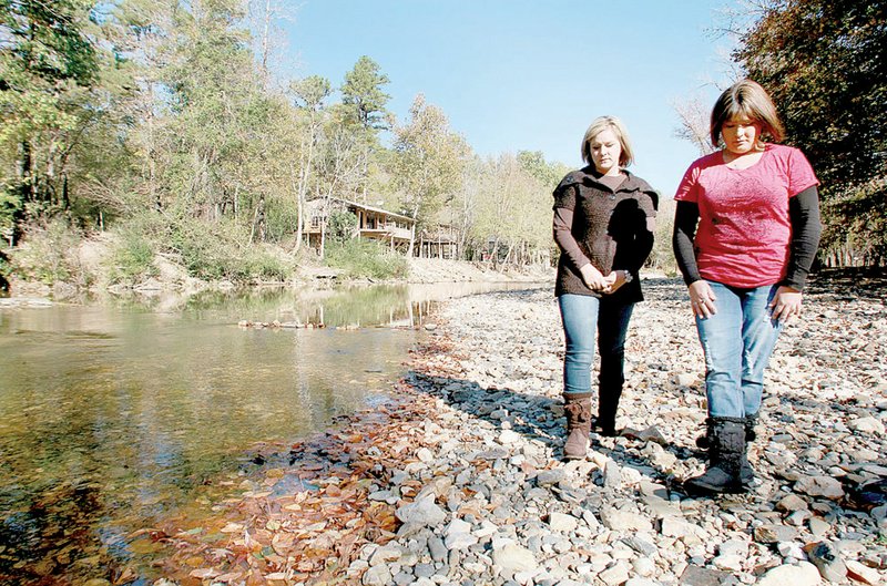 Candace Smith (left) and Kerri Basinger walk along the Little Missouri River five months after surviving the June 11 flood at the Albert Pike Recreation Area.
