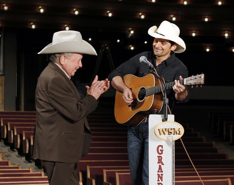 Brad Paisley, right, and Little Jimmy Dickens sing "Will the Circle be Unbroken" while standing on the circle in the center of the Grand Ole Opry House stage on Wednesday, Aug. 25, 2010 in Nashville, Tenn. The circle, made from a part of the old stage from the Opry's former home at Ryman Auditorium, was put back in place Wednesday after the rest of the stage was restored following flooding in May that left the stage submerged under 46 inches of water.