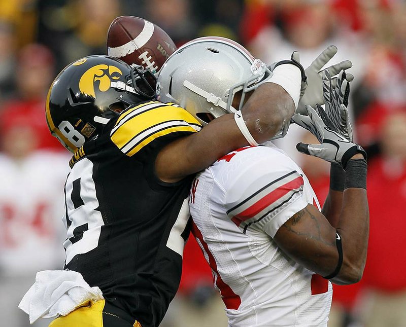 Iowa cornerback Shaun Prater (left) breaks up a pass intended for Ohio State receiver Corey Brown during the first half of the No. 9 Buckeyes’ 20-17 victory over the No. 20 Hawkeyes on Saturday in Iowa City, Iowa. 