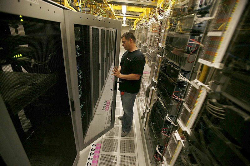 Verizon Wireless senior technician Jim Harper works last month in a switching center in Los Angeles that has one 4G server among dozens of 3G units. 