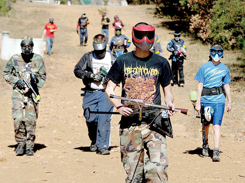 A group of players head up the road to Paintball Arkansas’ Ewok Village, the gallery’s most elaborate course. 