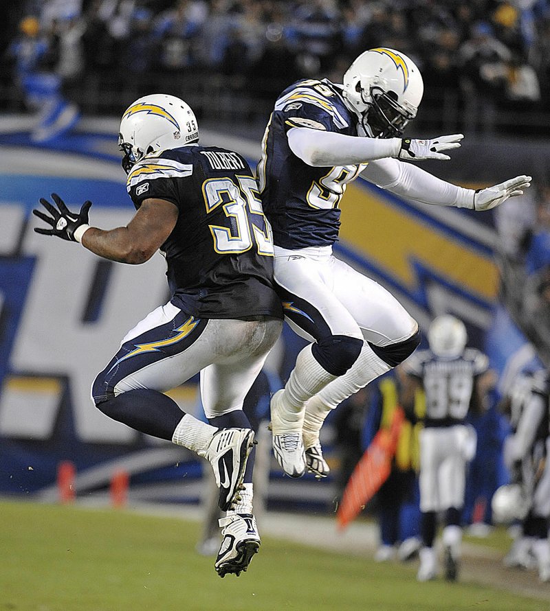 The San Diego Chargers’ Mike Tolbert and Kevin Burnett celebrate during their team’s 35-14 victory over Denver on Monday. 