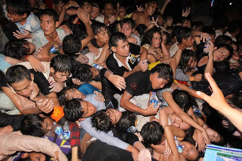 Cambodians are pushed onto a bridge Monday, the last day of celebrations of a water festival in Phnom Penh, Cambodia. 