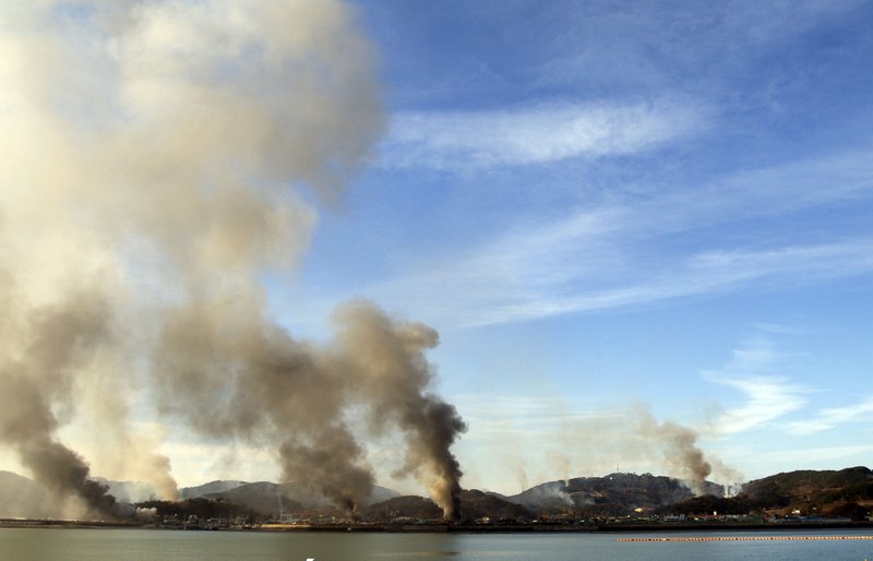 Smoke billows from Yeonpyeong island near the border against North Korea, in South Korea, on Tuesday, Nov. 23, 2010. 