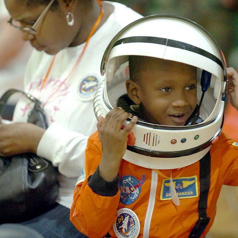 Rodney Blocker, 5, is dressed as an astronaut while waiting for NASA shuttle astronaut, author and physician Dr. Bernard Harris Jr. to address the student body at Cloverdale Aerospace Technology Conversion Charter Middle School on Monday afternoon. 