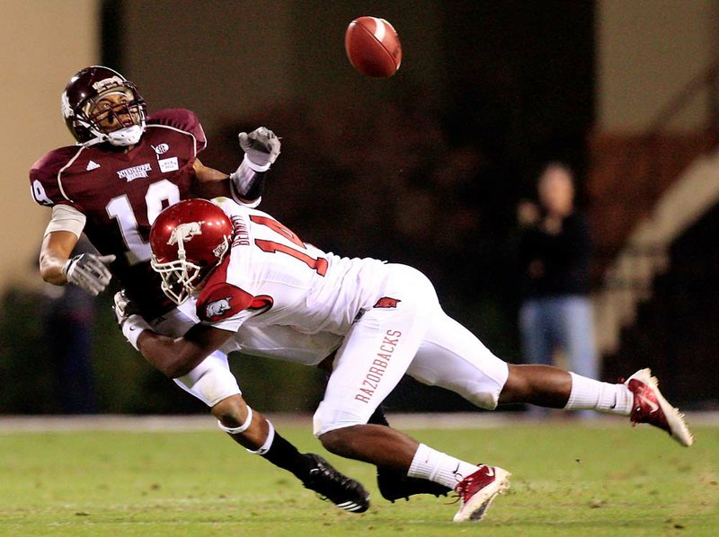 Arkansas freshman cornerback Eric Bennett, breaking up a pass intended for Mississippi State’s Arceta Clark in Saturday’s 38-31 double overtime victory in Starkville, Miss., has been one of several young defensive backs to step up for the Razorbacks in recent weeks. 