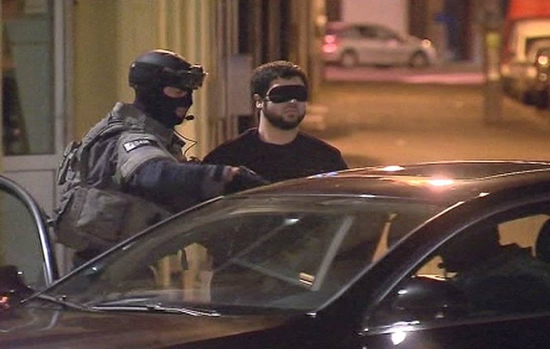  A suspect is detained Tuesday during an anti-terror sweep in Antwerp, Belgium, in this image taken from television.