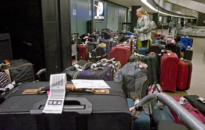 Jeannie Smith of Utah looks for her bag at the Southwest Airlines baggage claim in SeaTac Airport on Tuesday, Nov. 23, 2010. Monday's snows caused many passengers and their bags to arrive separately. 