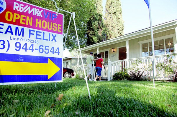 A couple arrives for an open house at a home for sale in Los Angeles earlier this month. Sales of previously owned homes slipped in October as the housing market continued to struggle. 